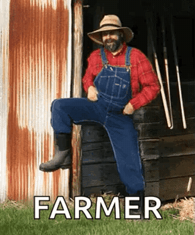 Farmer Sitting In Front Of Barn GIF