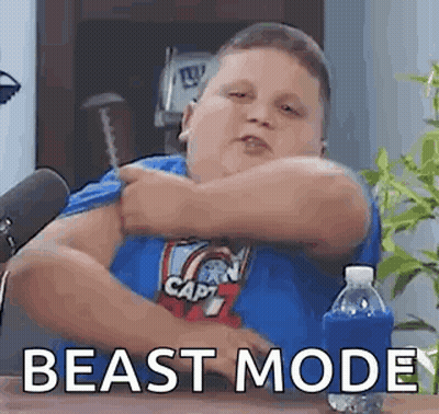 Fat Boy In Blue Shirt Sitting At Table With Water And Microphone GIF