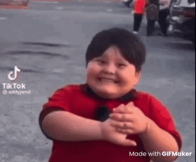 Fat Boy In Red Shirt Making Funny Face On Street GIF
