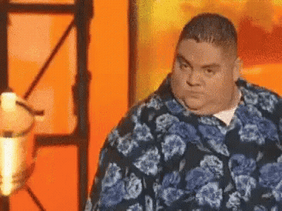 Fat Man In Blue Floral Shirt At Microphone GIF