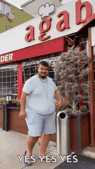 Fat Man In Front Of Restaurant With Trash Can GIF