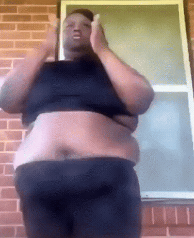 Fat Man Standing In Front Of Brick Wall GIF