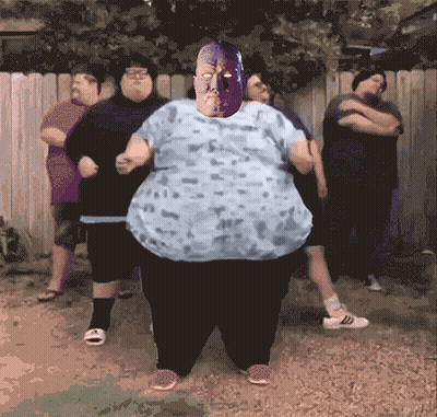 Fat People, One In Purple Mask, At Fence GIF