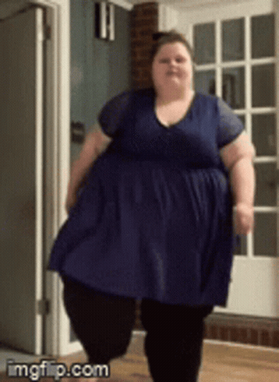 Fat Woman in Blue Dress Walking in Hallway