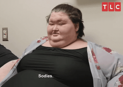 Fat Woman Says Sodies In Front Of TLC Sign GIF