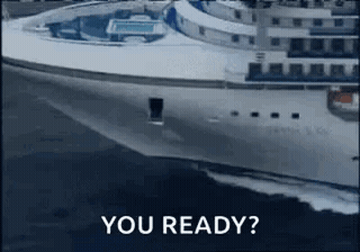 Feet Rest On Small Table Over Ocean GIF