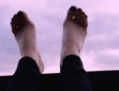 Feet Up In The Air Against Cloudy Sky GIF