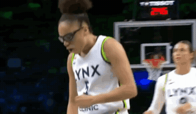 Female Basketball Player In Lynx Jersey Beside Hoop GIF