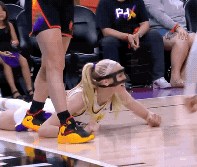 Female Basketball Player In Mask And PHX Shirt Lying On Floor GIF