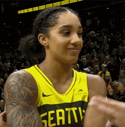 Female Basketball Player In Yellow And Green Jersey High-Fiving GIF