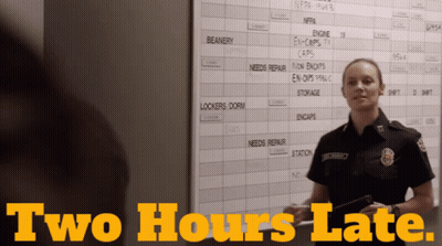 Female Firefighter In Front Of Board Saying Two Hours Late GIF