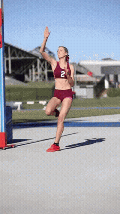 Female Runner In Maroon Top With Number 2 GIF