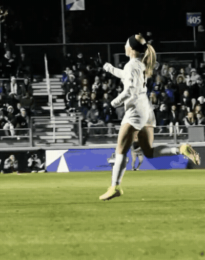 Female Soccer Player Running In Front Of 405 Sign GIF