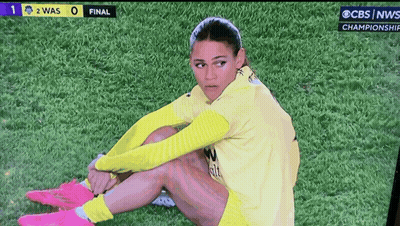 Female Soccer Player Sits On Field During CBS News Championship Game GIF
