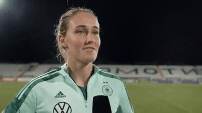 Female Soccer Player With Microphone On Field GIF