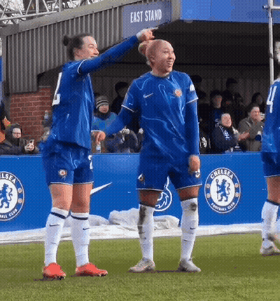 Female Soccer Players Standing In Front Of East Stand Banner GIF