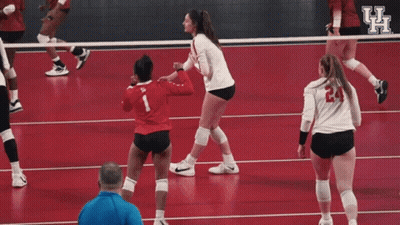 Female Volleyball Players Celebrating On Red Court GIF