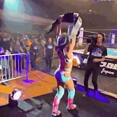Female Wrestler Holding Championship Belt Over Head GIF