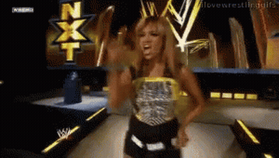 Female Wrestler Standing In Front Of NXT Screen GIF