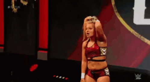 Female Wrestler Standing On Stage Holding Hair GIF