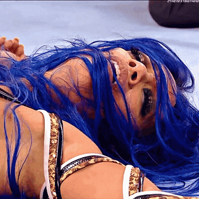 Female Wrestler With Blue Hair Laying Down GIF