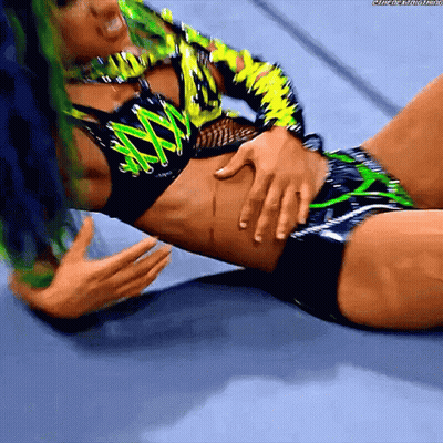 Female Wrestler With Green Hair Laying On Floor GIF