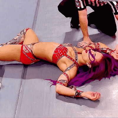 Female Wrestler With Purple Hair On Floor As Referee Watches GIF