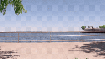 Fence Along Water With Building GIF