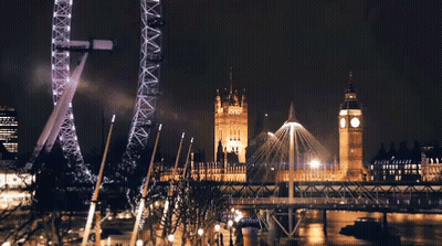 Ferris Wheel Lit Up At Night Near Big Ben GIF