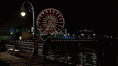 Ferris Wheel Lit Up At Night On Dock GIF