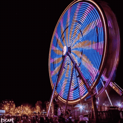 Ferris Wheel Lit Up At Night Saying Escape GIF