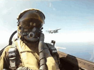 Fighter Jet Pilot In Helmet And Goggles Flying GIF