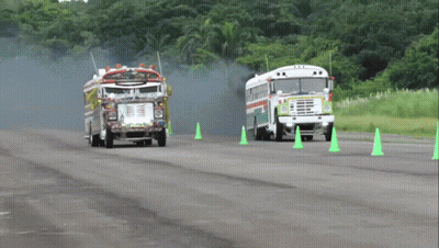 Fire Truck And School Bus Driving Past Green Cones GIF