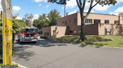 Fire Truck Parked In Front Of Building GIF