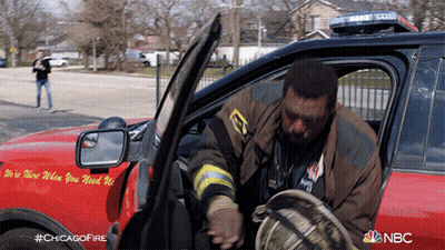 Firefighter Getting Out Of Chicago Fire Truck GIF