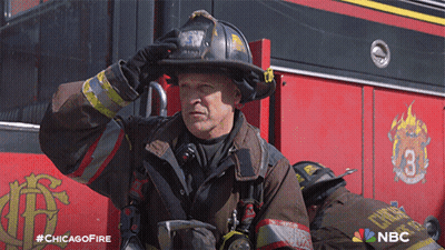 Fireman In Uniform In Front Of Chicago Fire Truck GIF