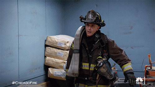 Fireman Standing In Front Of Bags With #Chicagofire GIF