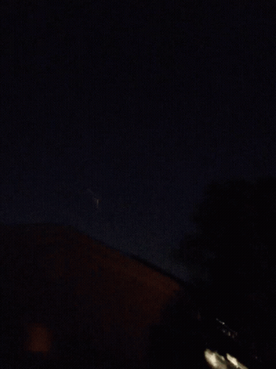 Fireworks Display In Night Sky Over House GIF