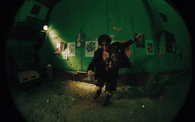 Fisheye Man In Room With Poster Saying A GIF