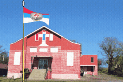 Flag Flying In Front Of Red Barn GIF