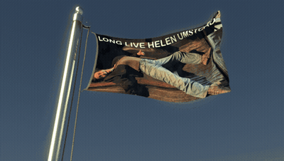 Flag With Man Laying Down Long Live Helen Umstead