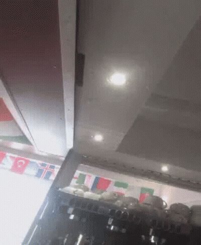 Flags Hanging Above Coffee Machine GIF