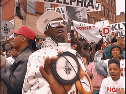 Flavor Flav Showing Off His Necklace GIF