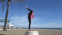 Flexible Woman Does One Leg Standing While Kicking GIF