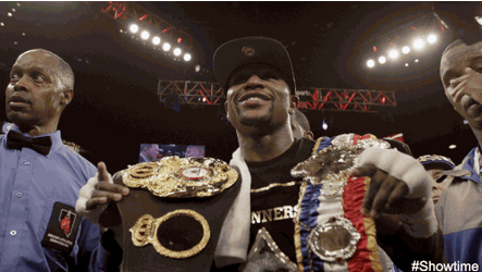 Floyd Mayweather Showcasing Championship Belts GIF