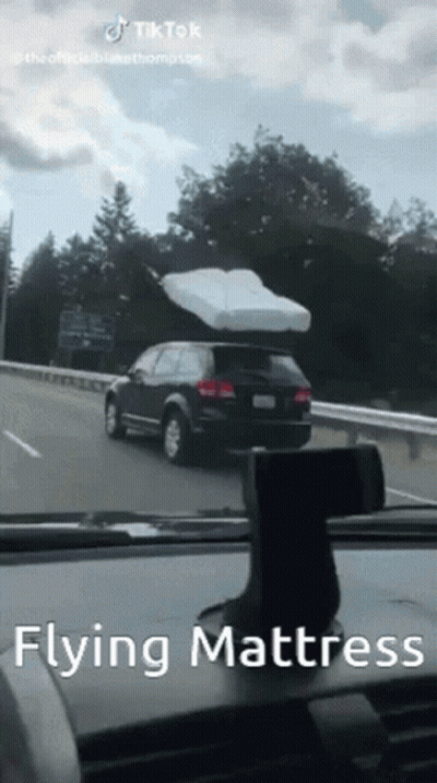 Flying Mattress On Car Highway GIF