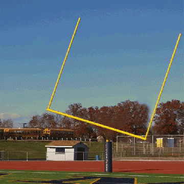 Football Field With Yellow Goal Post And White Shed GIF