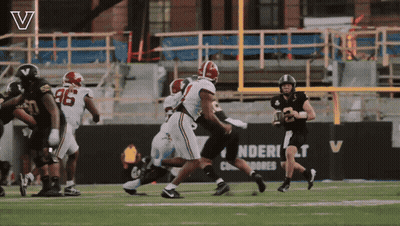Football Game In Front Of Sign Saying Ndert GIF