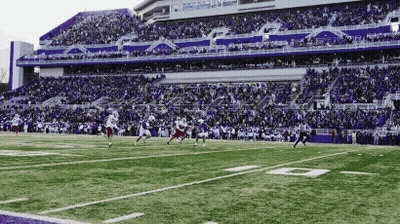 Football Game On Field With Purple Bleachers GIF