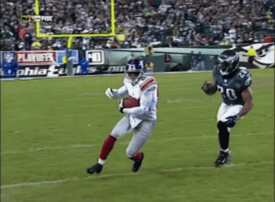 Football Game Played In Front Of Playoff Sign GIF